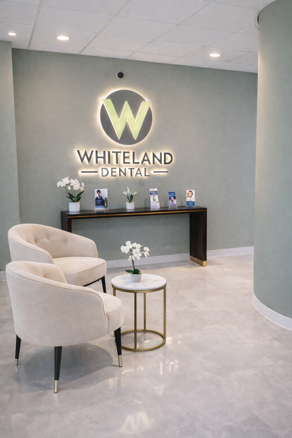 Welcoming front desk and signature logo wall at Whiteland Dental, the premier family and cosmetic dentist in Exton, PA
